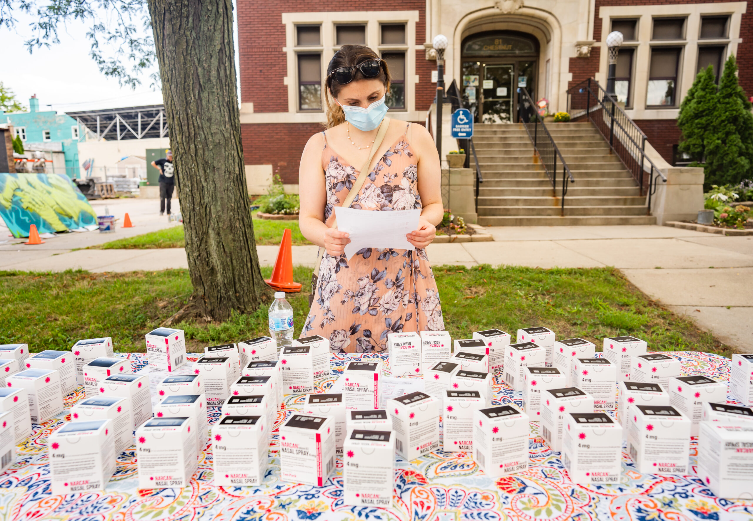 A Michigan resident reads about Naloxone – a lifesaving tool – at the Vital Strategies and Michigan Department of Health “Change at Your Own Pace” campaign art exhibit held in Detroit, MI